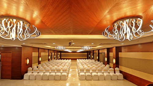 Theatre style seating arrangements with a desk on the podium inside the Banquet hall - VITS Devbhumi, Dwarka