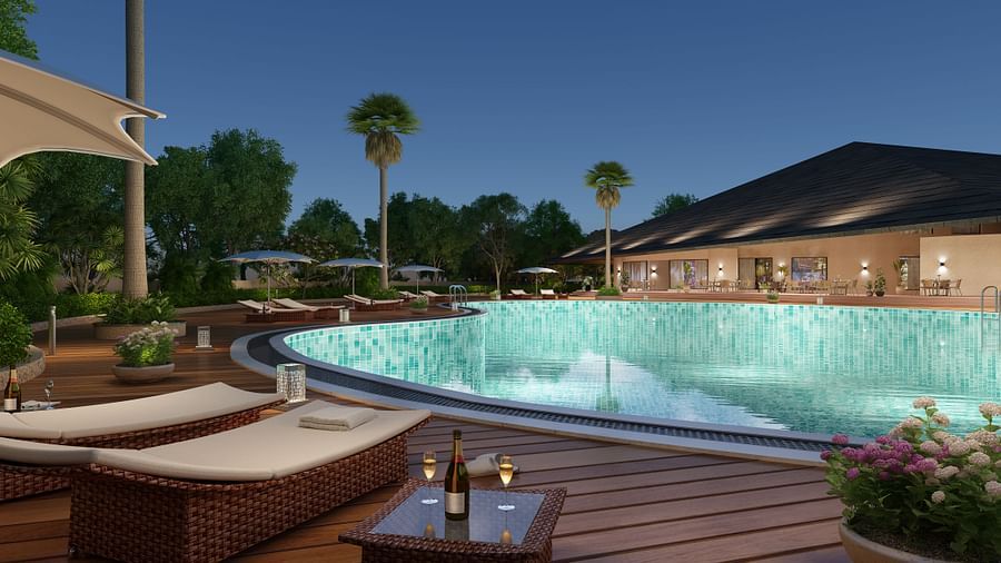 a large swimming pool with loungers next to it in the Club House - Ananta Spa and Resort, Ajabgarh