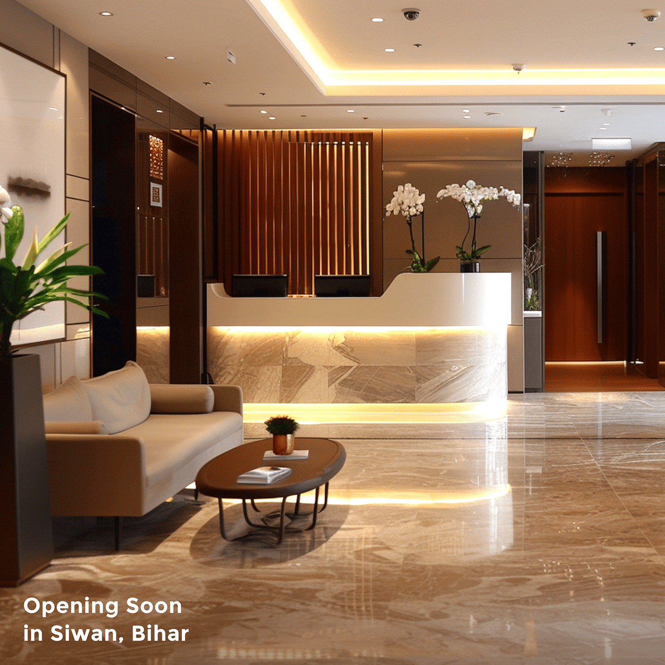 A sofa and coffee table placed next to the reception desk decked with flowers next to it and warm lighting as the text says 'Opening Soon in Siwan, Bihar'