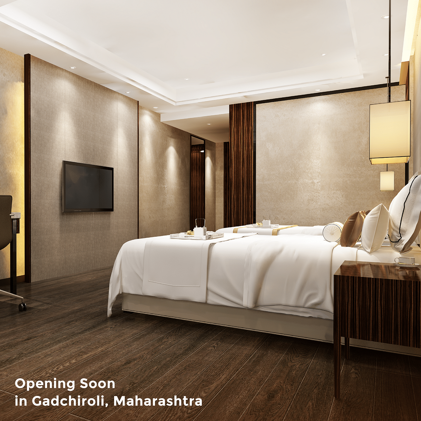 An image of a twin bed in a warm-lit room with a TV in front of it and kettle on a tray seated on the beds as the text says 'Opening Soon in Gadchiroli, Maharashtra' 