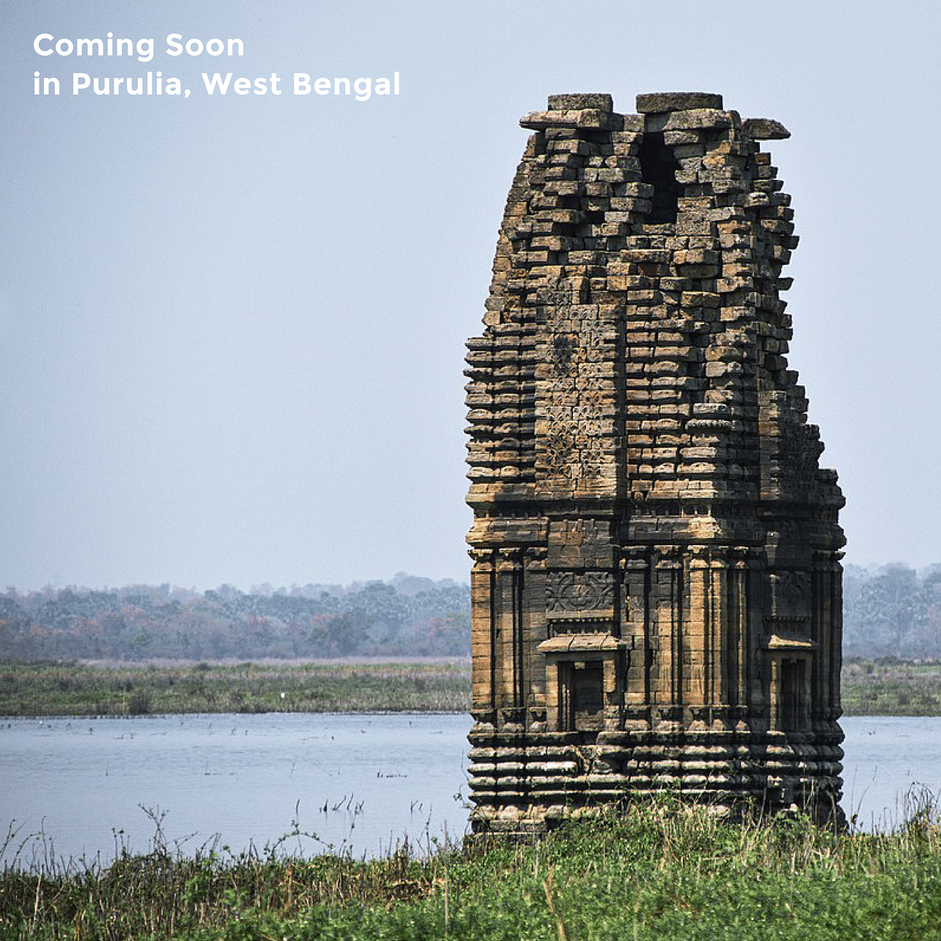 Remnants of a temple standing next to a river under clear sky as the text says 'Coming Soon in Purulia, West Bengal'