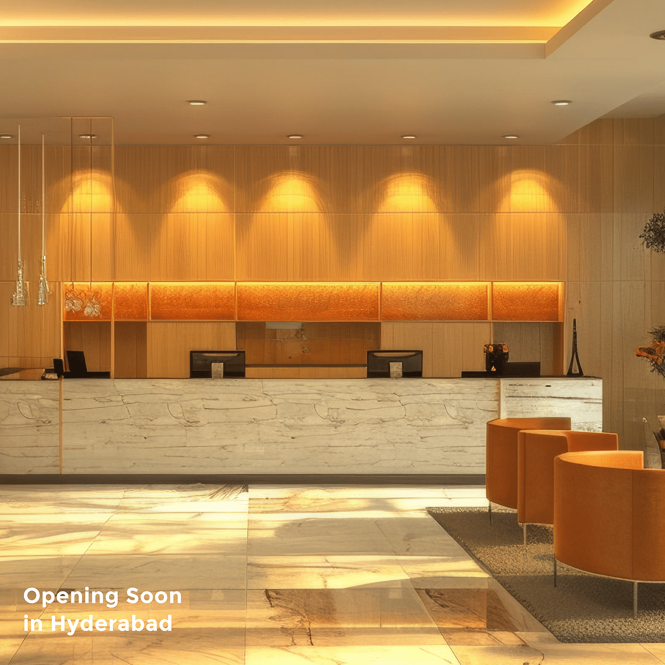 An image of a reception desk and seating area next to it in all orange theme under warm lighting as the text says 'Opening Soon in Hyderabad'