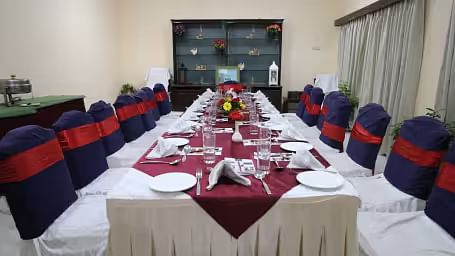 Banquet hall elegantly arranged with tables and chairs, ready for a festive celebration.