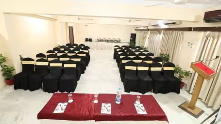 Pelican Event Hall features a large conference table at the front, with seating sections arranged on both the left and right sides