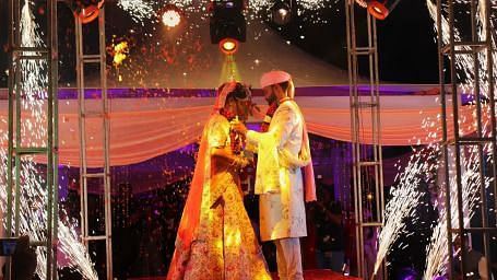 A couple getting married on stage at Swosti Resorts
