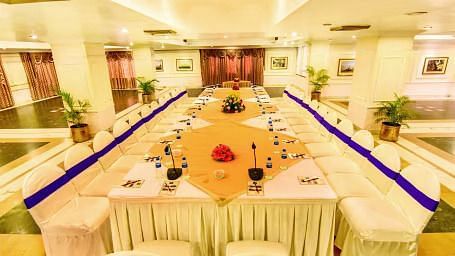 Interiors of a banquet hall at Swosti Resort with a u-shaped seating arrangemet