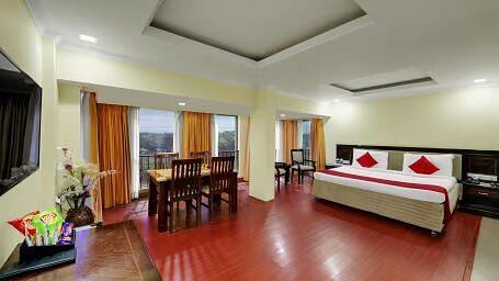 A Club Suite with a comfy bed, dining table flat screen Tv at Hotel SRM Chennai 