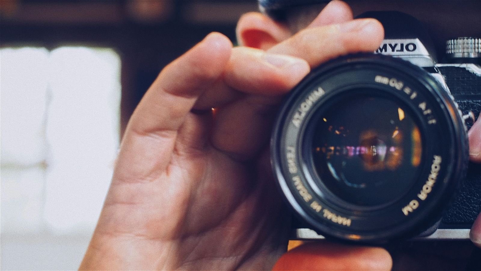 A hand holding a camera