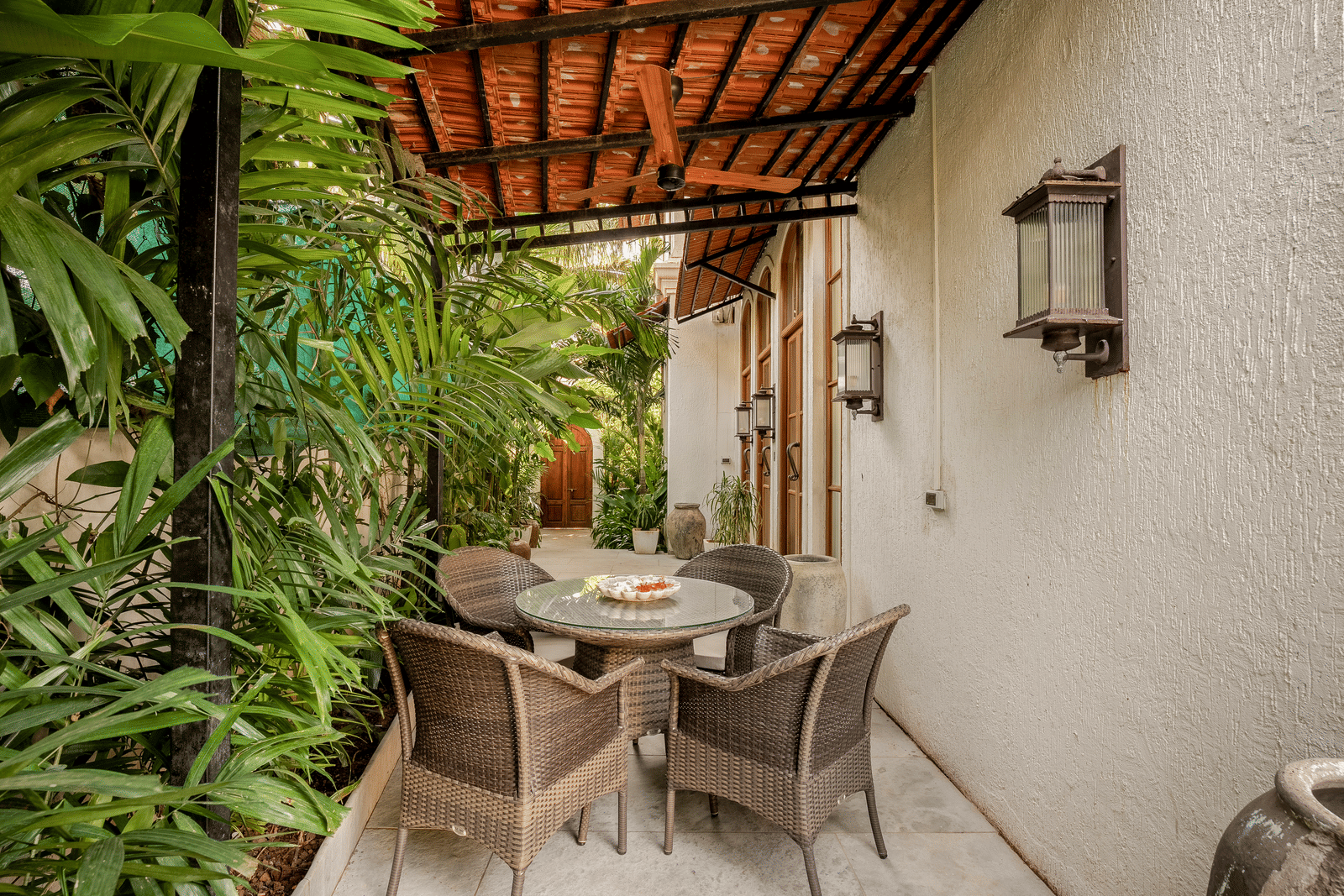 Outdoor dining area with table and chairs surrounded by lush greenery at Linday Manor