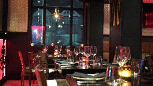 Dining arrangement at a restaurant at night with moody lighting