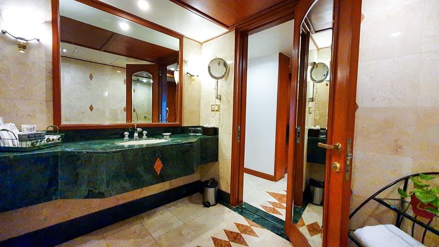orchid suite bathroom designed with vibrant colours and wooden interiors - The Orchid Hotel Mumbai Vile Parle