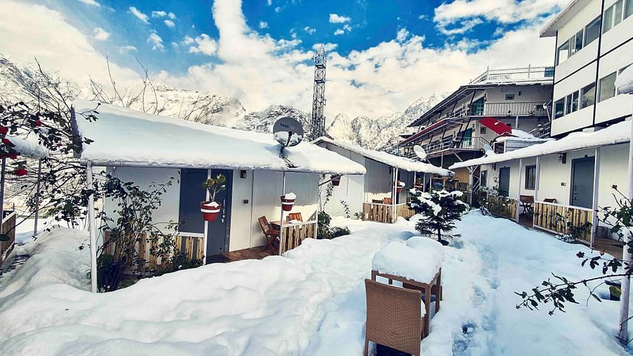 facade image of the Tattva Boutique Resort in joshimath with a think cover of white snow all over the place