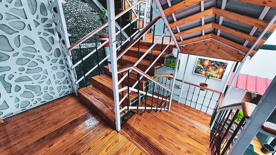 image of a staircase leading downstairs with wooden flooring at the tattva, joshimath