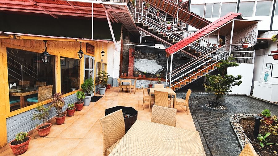 image of the outdoor seating area with staircase leading upstairs at the tattva, joshimath