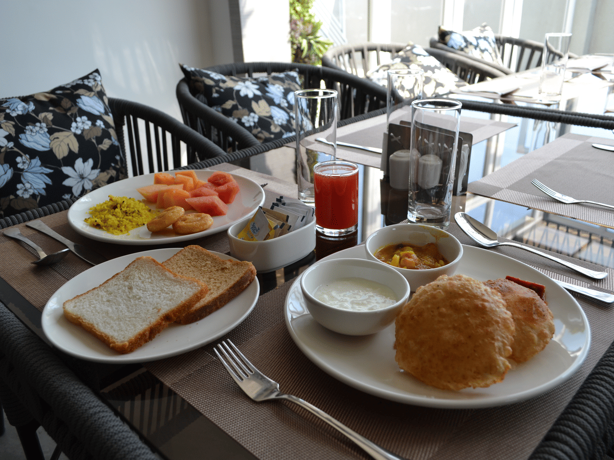 A breakfast spread of fruit, poha and fresh juice at Signum Resort, Bandhavgarh
