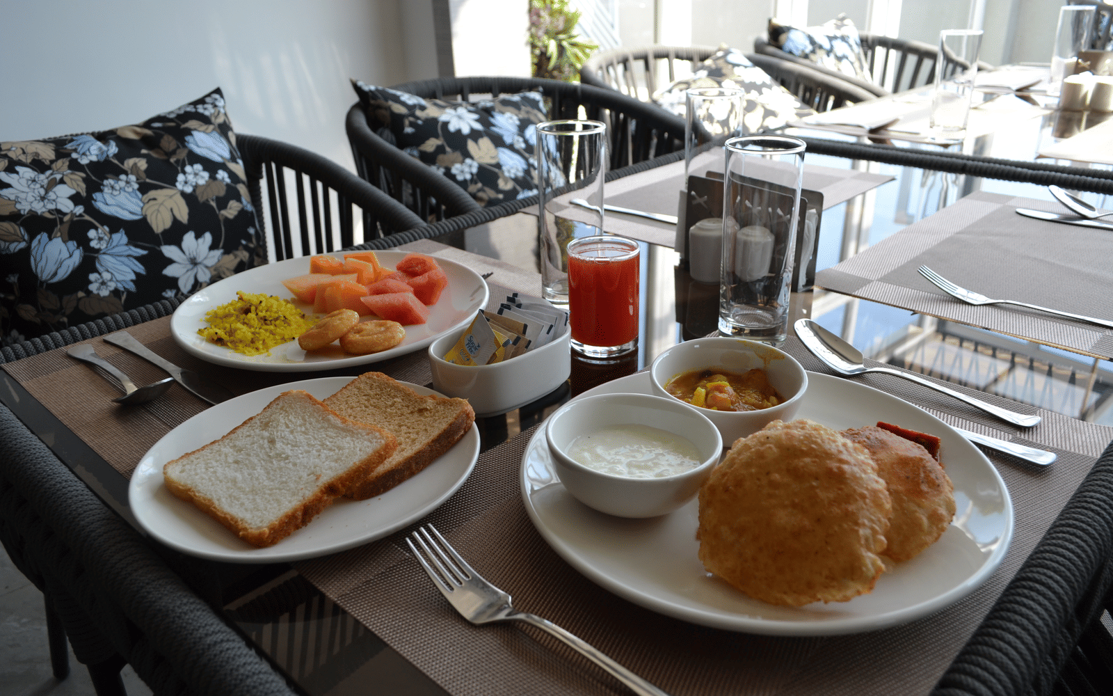 A breakfast spread of fruit, poha and fresh juice at Signum Resort, Bandhavgarh