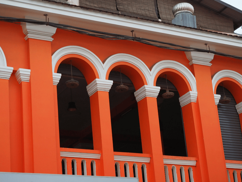 vibrant arched corridors featuring stark white columns and trim, highlighted by bright directional light