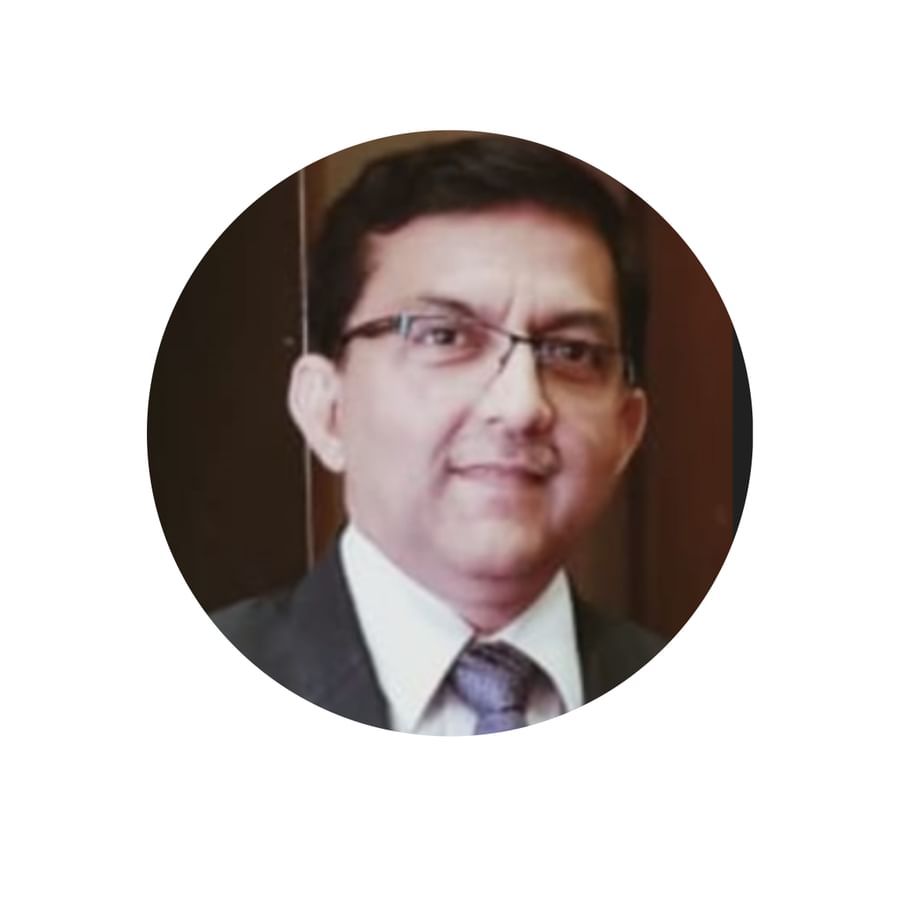  Vinay Kumar Singh wearing a dark suit, light shirt, and a purple tie, standing indoors