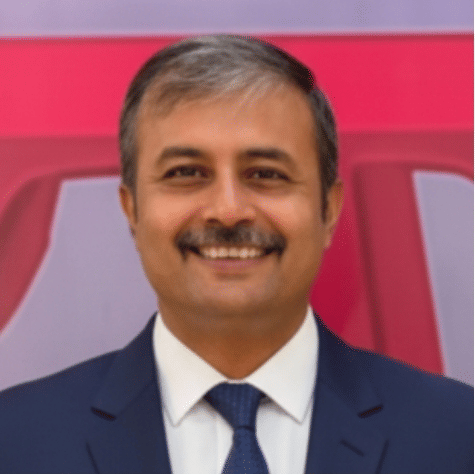 Executive team member in business suit at Pride Hotels Group.