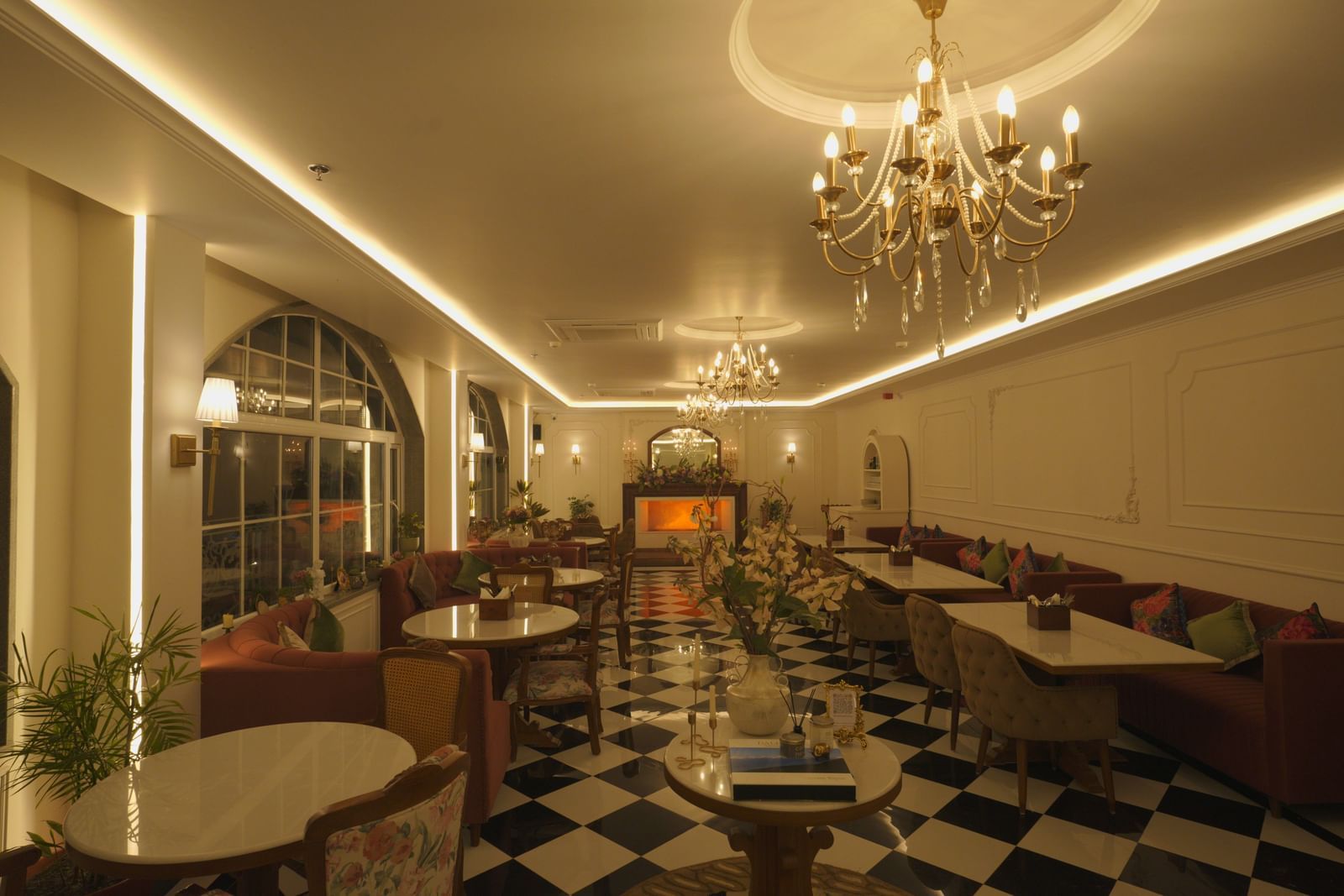 Elegant dining hall with chandeliers, arched windows, and chequered flooring - Mayfair Cafe & Suites, Dalhousie