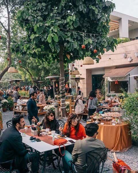 Guests seated outdoors during a food event or meal gathering at Karma Chalets.