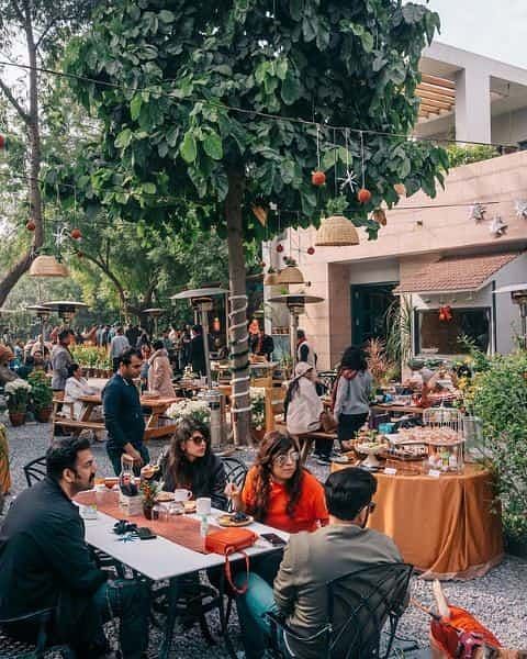 Guests seated outdoors during a food event or meal gathering at Karma Chalets.
