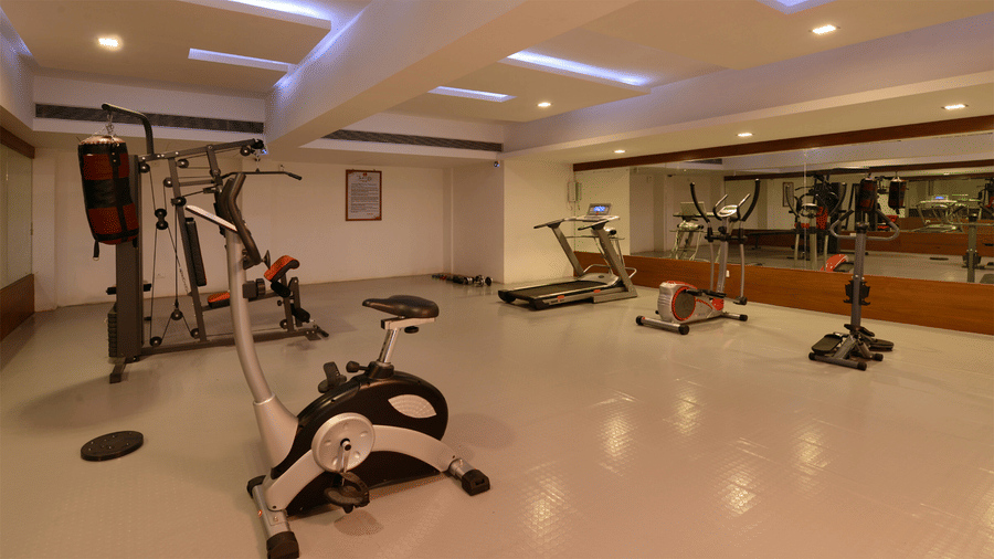 gym area of Top3 Lords Resort Bhavnagar with fitness equipments and mirrored walls