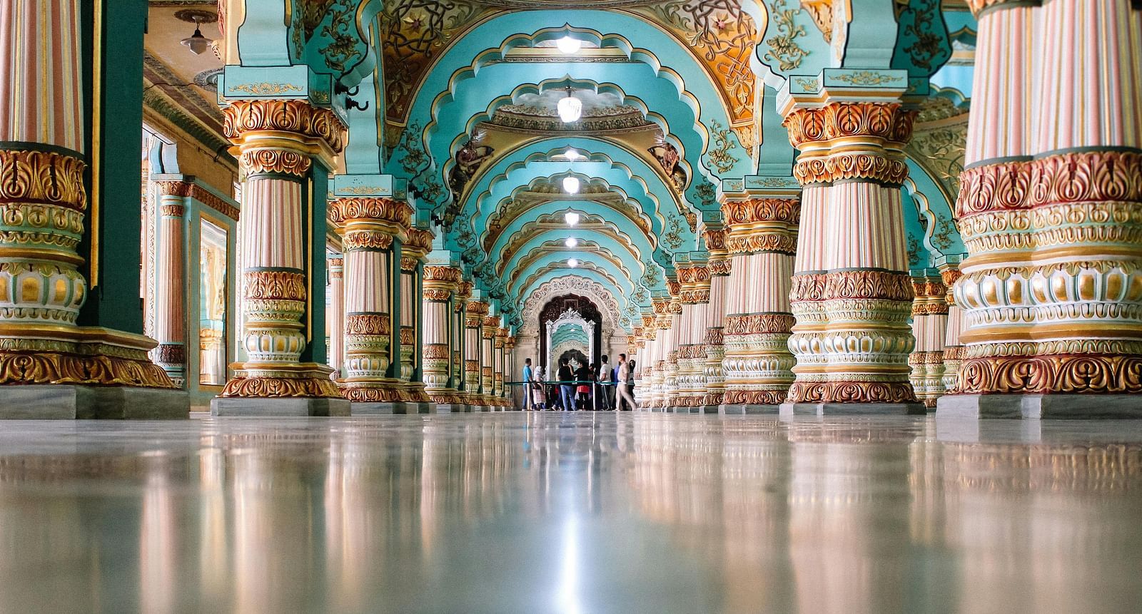 An image of the inside of a palace with ornamental decorations in the pillars