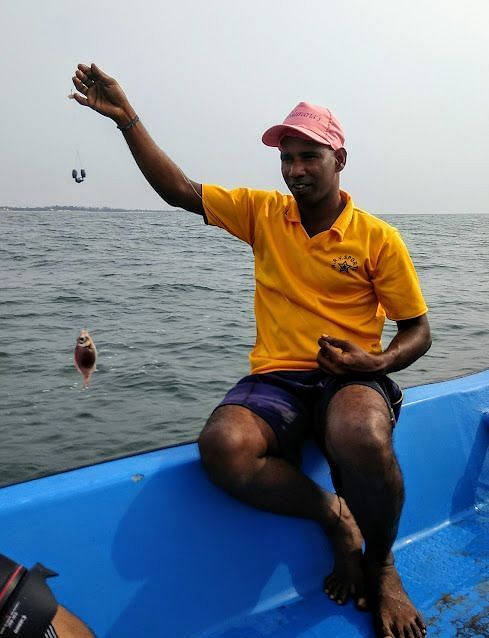 A person catching fish using a fishing thread.