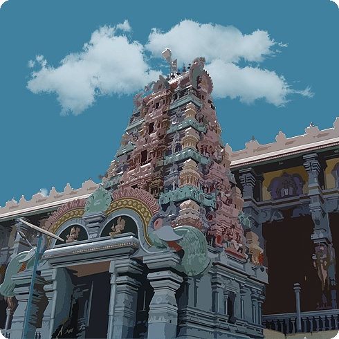 A temple's ornate entrance with colourful carvings and stone pillars under a cloudy blue sky.