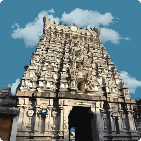 A large, white temple gopuram against a clear, blue, cloudy sky.