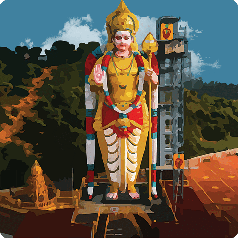 A tall, colourful statue of a deity standing outdoors on a plinth amidst green hills.