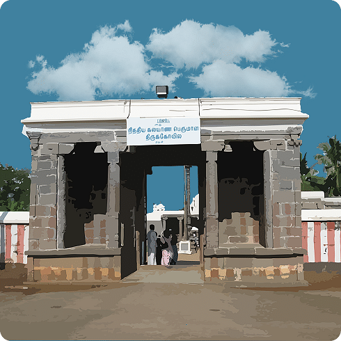 A large, grey temple entrance with pillars and a doorway, under a blue, cloudy sky.