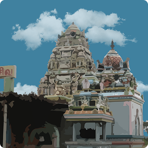 A traditional temple with a stone gopuram and colourful domes against a blue, cloudy sky.