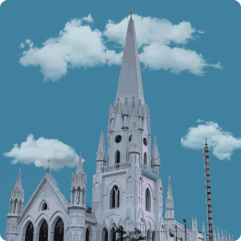 A tall, white Gothic-style church with spires pointing skywards, surrounded by smaller steeples.