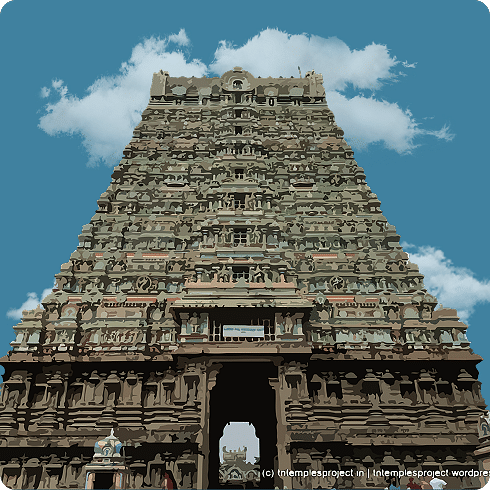 A large, grey temple gopuram with multiple tiers and intricate carvings under a cloudy sky.