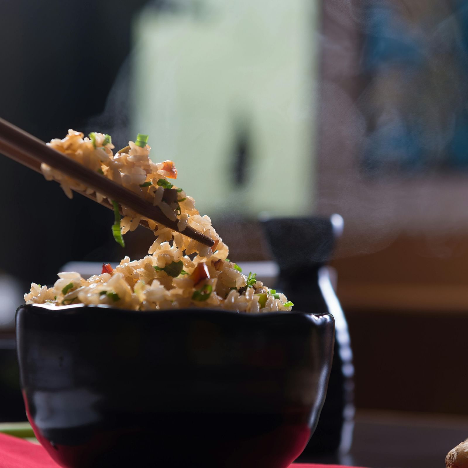 image of a chinese food preparation picked up by a pair of chopsticks