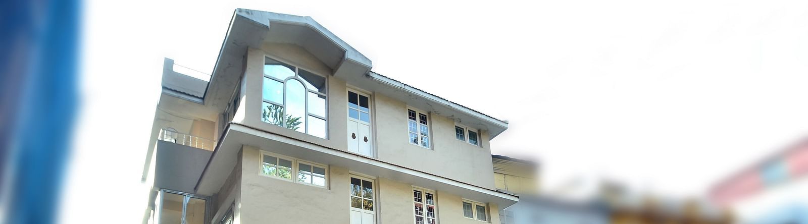 Facade of BN Tourist Home with a car parked in front of it.