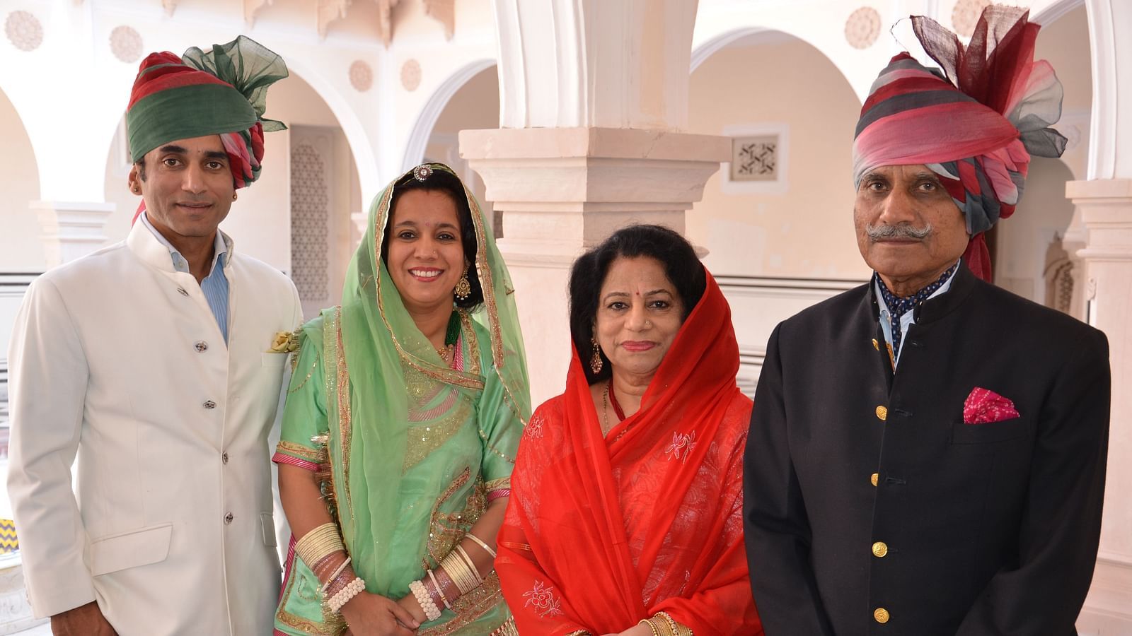 Shot of hosts of Khas Bagh, Jaipur standing infront of the property wearing traditional attire.