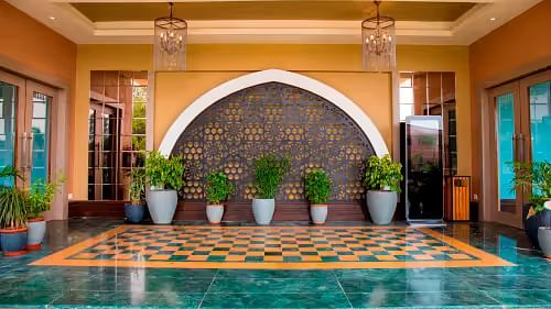 Mahogany hall front with potted plants and checkered tiles