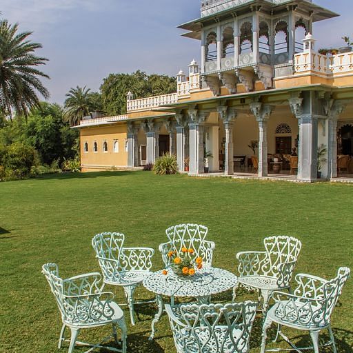 facade image of Dev Shree during the day with an outdoor seating area in the foreground