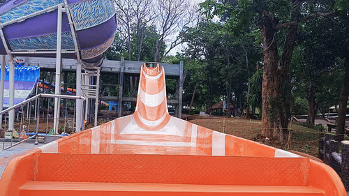 Top view of an high-speed water slide at Black Thunder water park surrounded by trees