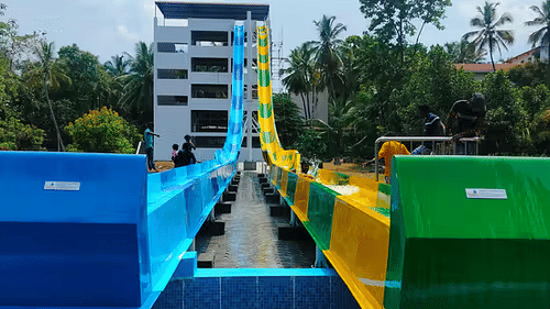 Two blue and green water slide lanes side-by-side, ready for riders - Black Thunder Water Theme Park