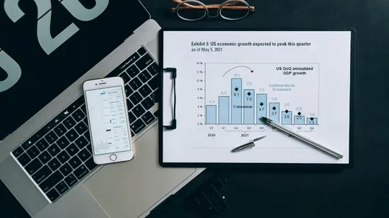 Stationary items featuring a shart showing the analytical data, a smartphone, and a laptop.