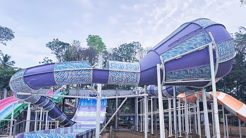 Twisting tube water slides at Black Thunder Water Park with a vibrant and modern splash zone setup.