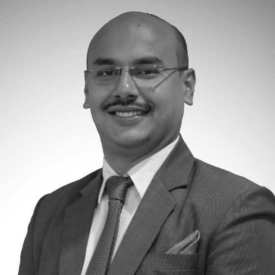 Debabrata Ray, Corporate Director of Food & Beverage at BluSalzz Hospitality, wearing a formal suit and tie in a professional corporate portrait.