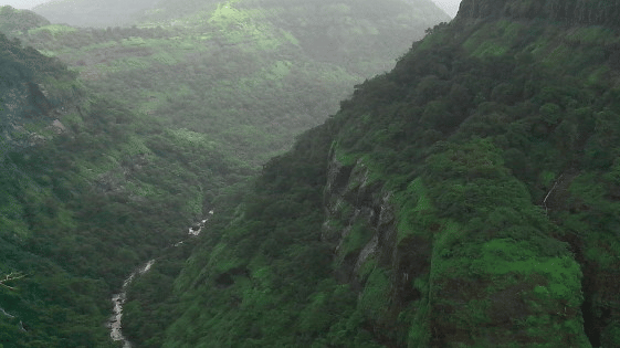 A panoramic view of the Shooting Point, one of the Khandala Hills, with mountains covered with lush trees amid misty surroundings