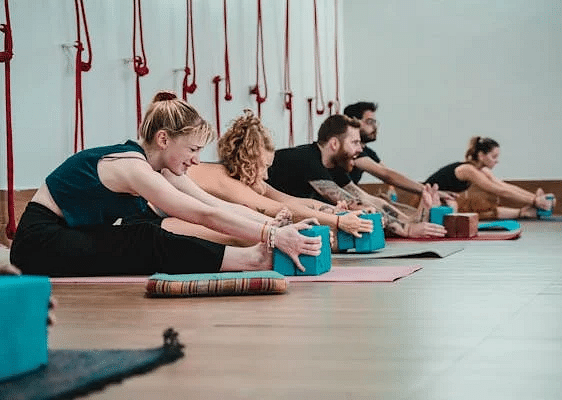 A group of women exercising on yoga mats.