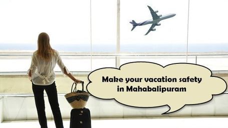 A woman standing near an airport window with a suitcase and a bag, watching an airplane take off, with the words 'Make your vacation safety in Mahabalipuram', on the image.