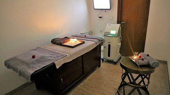 A massage table in a dimly lit room, indoor setting - Shreyas Retreat